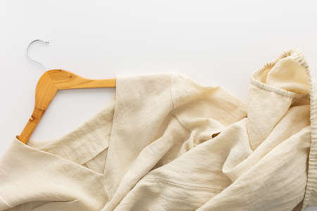 Wooden hanger with linen dress isolated on a white backgroundの写真素材