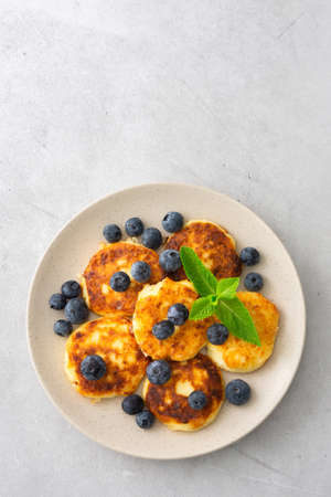 Cottage Cheese Pancake with blueberries and mint in a plate on a gray backgroundの写真素材