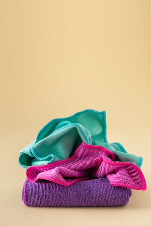Multicolored microfiber cloths for washing on a neutral beige background, cleaning concept