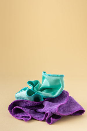Multicolored microfiber cloths for washing on a neutral beige background, cleaning concept
