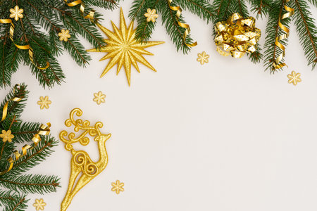 Festive background with gold decoration , green spruce branches and shiny golden serpentine confetti, golden deer and star ,glittering snowflakes , flat lay, top view, copy spaceの写真素材