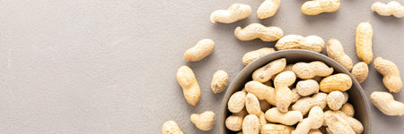 Legumes in bowl and scattered in the background, peanuts in a plate banner, top view, copy spaceの写真素材