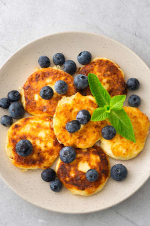 Cottage Cheese Pancake with blueberries and mint in a plate on a gray backgroundの写真素材