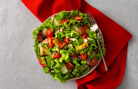 Light summer fresh salad with tomatoes and lettuce, chicken breast and pineapple with balsamic sauce, top viewの写真素材