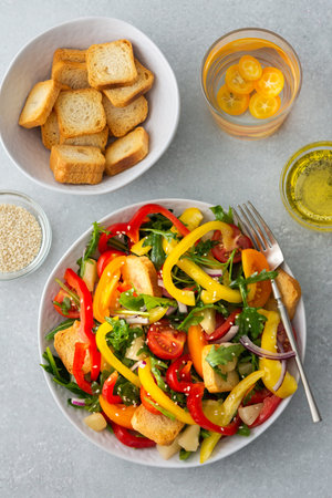 Light summer fresh salad with colorful tomatoes and croutons, sweet peppers and pineapple with...