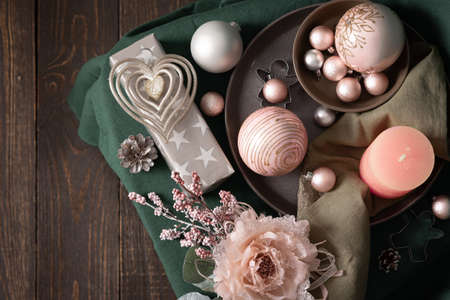 Christmas composition in sail champagne ,green and gray shades, christmas balls and candle, cookie cutters and decorative flower on a green tablecloth, top view, copy spaceの写真素材