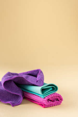 Multicolored microfiber cloths for washing on a neutral beige background, cleaning conceptの写真素材