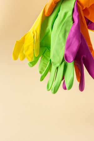 Multicolored working rubber gloves to protect hands while washing close up, cleaning conceptの写真素材