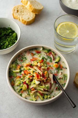 Soup from fresh ripe vegetables with sour milk drink, Russian traditional soup okroshka, top viewの写真素材