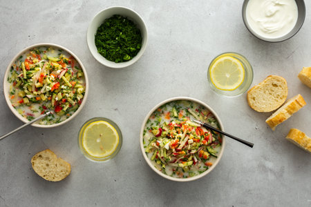 Soup from fresh ripe vegetables with sour milk drink, Russian traditional soup okroshka, top view