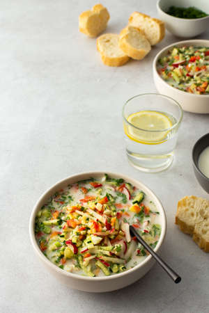 Soup from fresh ripe vegetables with sour milk drink, Russian traditional soup okroshka, top viewの写真素材