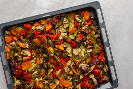 Fresh assorted autumn cut vegetables on a baking sheet, oven baked vegetables, top viewの写真素材