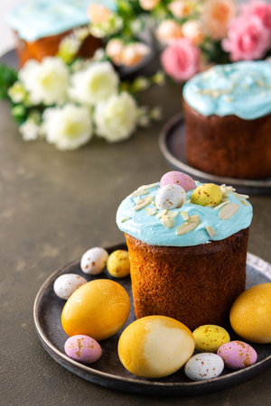 Festive table, Easter cake decorated with glaze, almond flakes and colorful eggs, Happy Easter