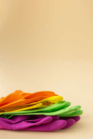 Multicolored working rubber gloves to protect hands while washing close up, cleaning conceptの写真素材