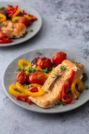 Baked red fish fillet Arctic char on a plates with vegetables close up, delicious hearty healthy dinnerの写真素材
