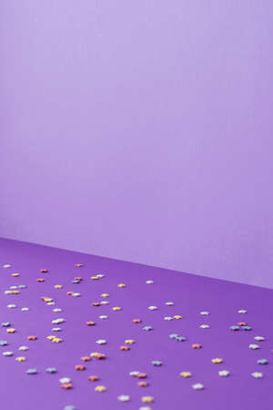 Purple background from one wall and floor, multicolored stars on the floor, holiday concept or birthdayの写真素材