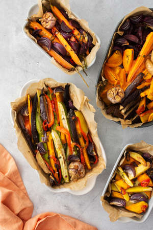 Fresh stewed vegetables baked in the oven, top view of vegetables in various ceramic dishesの写真素材