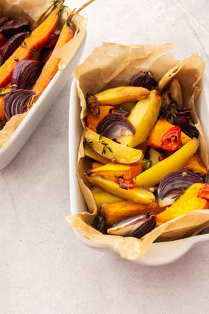 Fresh stewed vegetables baked in the oven, top view of vegetables in various ceramic dishesの写真素材