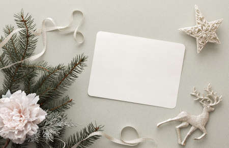Christmas tree decorations, decorative flowers with ribbon and fir branches on a green background, festive mockup, top view, copy spaceの写真素材