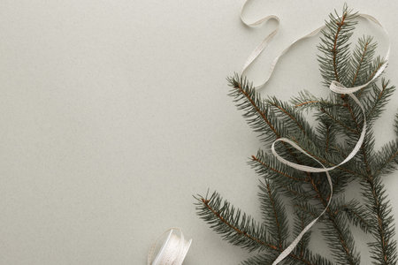 Spruce branches with ribbon on a green background, Merry Christmas and Happy New Year concept, top...