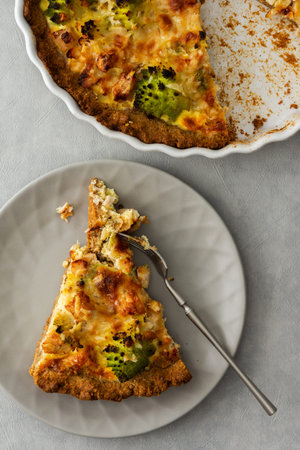 Homemade baked pot pie on a gray background, piece of pot pie with Romanesco cabbage, chicken breast...