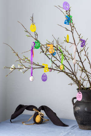 Blooming cherry branches decorated with colorful ribbons with Easter eggs, Happy Easter, napkin and egg rabbitの写真素材