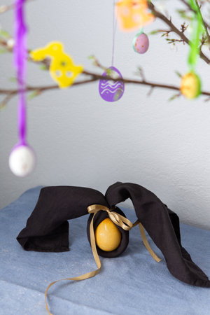 Blooming cherry branches decorated with colorful ribbons with Easter eggs, Happy Easter, napkin and egg rabbitの写真素材