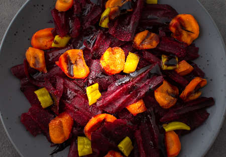 Warm salad with boiled carrots and beetroot and green peppers, top viewの写真素材