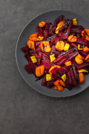 Warm salad with boiled carrots and beetroot and green peppers, top viewの写真素材