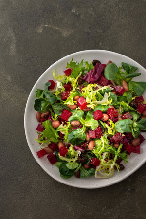 Warm salad with mixed salad with boiled beetroot and beans with spices, top viewの写真素材