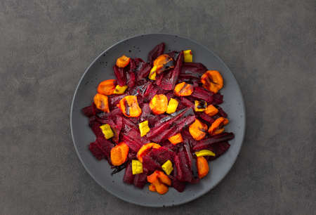 Warm salad with boiled carrots and beetroot and green peppers, top viewの写真素材
