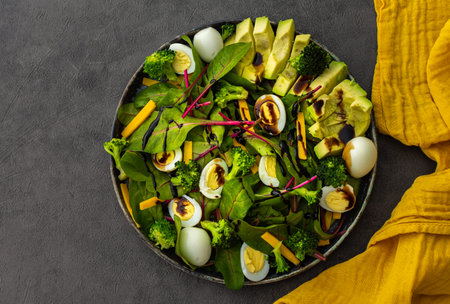 Beetroot leaves Chard with with quail eggs, avocado and Cheddar cheese, healthy fresh salad with...