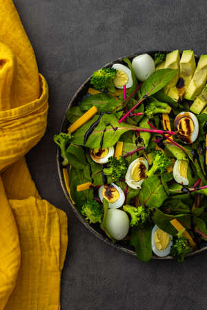 Beetroot leaves Chard with with quail eggs, avocado and Cheddar cheese, healthy fresh salad with balsamic vinegar, top viewの写真素材