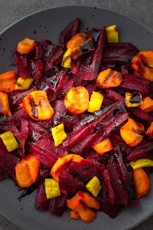 Warm salad with boiled carrots and beetroot and green peppers, top viewの写真素材