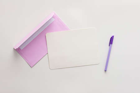 Violet envelope with blank paper and pen, greeting card or invitation mockup, top view, copy spaceの写真素材