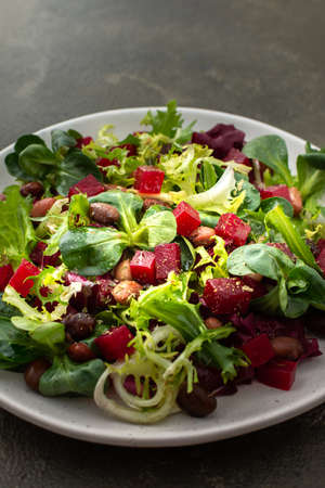 Warm salad with mixed salad with boiled beetroot and beans with spicesの写真素材