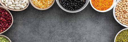 Banner of various types of legumes in bowls, green and yellow peas, chickpeas and peanuts, colored beans and lentils, mung beans and beans, top view, copy spaceの写真素材