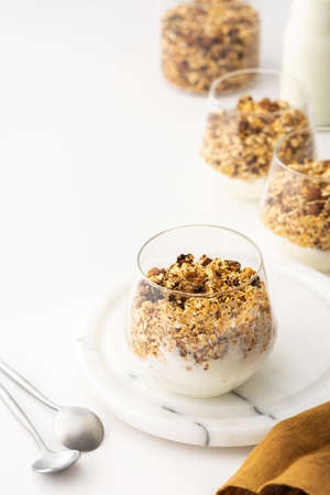 Homemade granola with almonds in a glass with yogurt, delicious healthy breakfastの写真素材