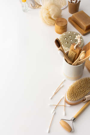 Wooden toothbrushes with natural bristles in a ceramic glass, face and skin care products, bath accessories, spa and beauty conceptの写真素材