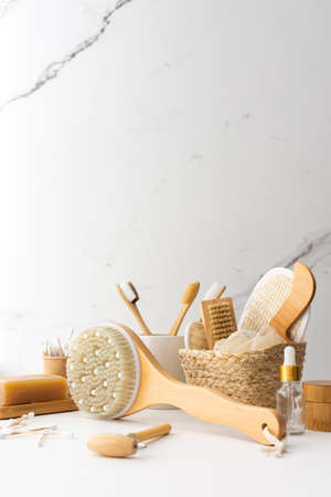 Wooden toothbrushes with natural bristles in a ceramic glass, face and skin care products, bath accessories, spa and beauty conceptの写真素材