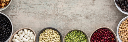 Banner of various types of legumes in bowls, green and yellow peas, chickpeas and peanuts, colored beans and lentils, mung beans and beans, top view, copy spaceの写真素材
