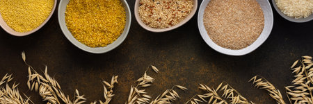 Various grain cereals in bowls banner, top view on a brown background with bowls of cereals and ears of oatsの写真素材