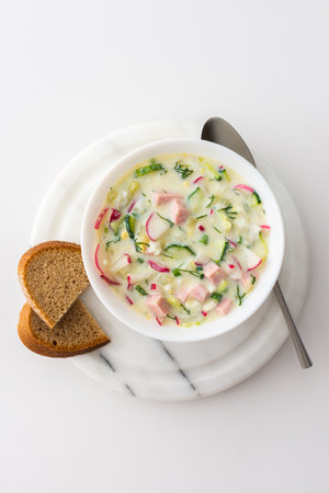 Cold soup Okroshka, soup with fresh vegetables and kefir, delicious summer traditional Ukrainian or Russian soupの写真素材