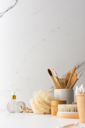 Wooden toothbrushes with natural bristles in a ceramic glass, face and skin care products, bath accessories, spa and beauty conceptの写真素材