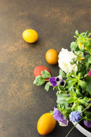 Top view of a vase with beautiful blooming flowers and Easter eggs, copy spaceの写真素材