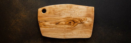 Empty cutting board for groceries on brown background, top view, copy spaceの写真素材