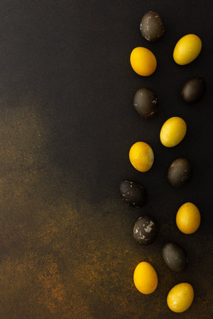Cosmic Easter eggs on a brown background, top view, copy spaceの写真素材