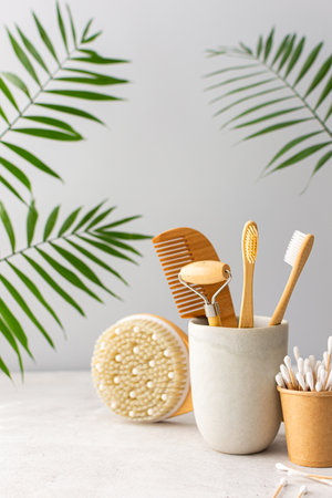 Wooden toothbrushes with natural bristles in a ceramic glass, face and skin care products, bath accessories, spa and beauty conceptの写真素材