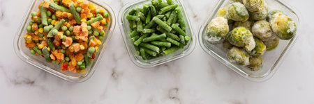 Frozen vegetables in containers banner , frozen cauliflower and asparagus beans, peas and corn, Brussels sprouts and carrots, mix of vegetables, top view, copy spaceの写真素材