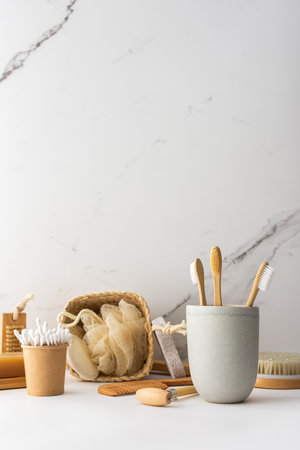 Wooden toothbrushes with natural bristles in a ceramic glass, face and skin care products, bath accessories, spa and beauty conceptの写真素材